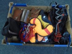 A box of dog training toys, metal spikes, flasks,