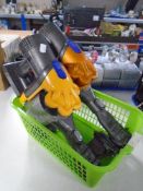 Two handheld Dyson vacuums.