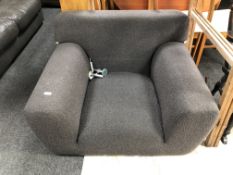 An armchair on chrome legs upholstered in charcoal fabric, as seen on Channel 4's 'Big Brother'.