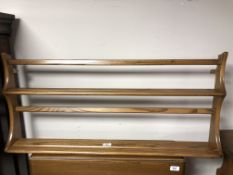 An Ercol elm and beech wall delft rack.