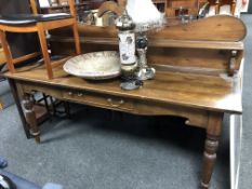 A late 19th century oversized pine hall table with shelf, fitted with a drawer.