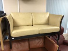 A late 20th century Skalma wooden framed two seater settee in cream leather