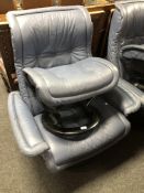 A Stressless blue leather adjustable reclining armchair with stool.