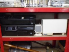 Two HP printers together with a set of Altec Lansing computer speakers.