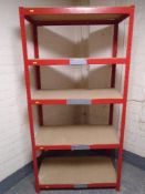 A five tier red metal shelving unit.