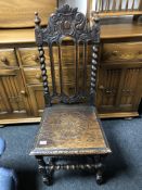 An Edwardian barley twist carved oak hall chair.