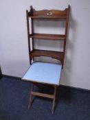 A set of oak Arts and Crafts open bookshelves together with a folding campaign style occasional