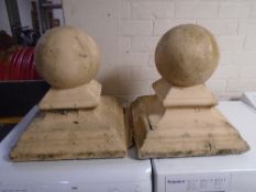 A pair of concrete pillar caps.