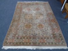 A fringed wooden rug with geometric design.