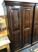 A reproduction mahogany double door wardrobe.
