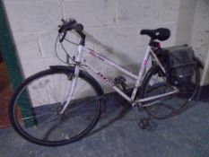 A lady's Emmelle Adventurer hybrid bike with rear panniers.