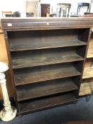 A continental oak open bookcase on bun feet.