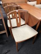 A set of three mid-20th century teak dining chairs.