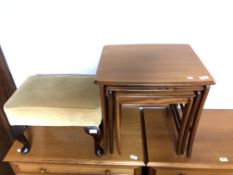 A nest of three 20th century teak tables together with a dralon upholstered footstool.