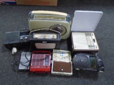 A box containing assorted transistor and DAB radios including Bush, Roberts and Pure.