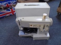 A Singer electric sewing machine in case.