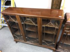 A Chapmans Siesta mahogany triple door bookcase with glazed doors (width 123cm).