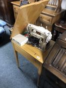 A Singer electric sewing machine in table.