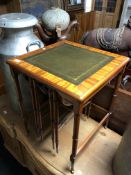 A nest of three good quality tables, one with inset leather panels.