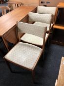 A set of three mid-20th century teak dining chairs.