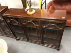 An Edwardian mahogany triple door bookcase with glazed doors (width 130cm).