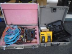 Two aluminium cases containing fibre optic Megger testers, wires, components,