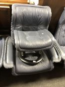 A Stressless blue leather adjustable reclining armchair with stool.