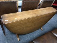 An Ercol elm and beech drop leaf table.