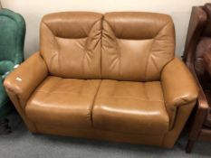 A Scandinavian brown leather two seater settee