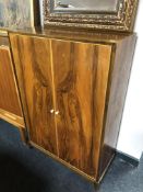 A mid-20th century walnut double door cabinet.