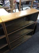 A mid-20th century three tier stacking bookcase with sliding glass doors (width 91.5cm).