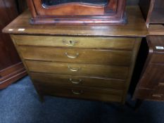 A mid-century five drawer chest with brass drop handles.