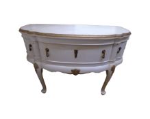 A continental white and gilt shaped fronted three drawer buffet sideboard width 124 cm