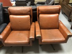 A pair of Danish 1970's armchairs in brown leather on chrome bases