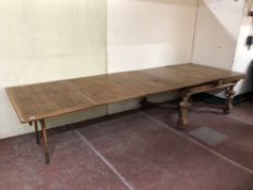 An antique continental oak extending dining table on bulbous legs,