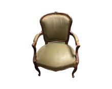 A French carved beech framed salon armchair in brown fabric