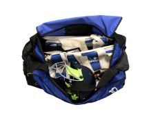 A Kukuburra cricket bag containing helmet, pads, cricket balls,