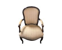 A French carved beech framed salon armchair in Regency stripe fabric