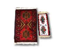 An Afghan rug, 68cm by 42cm, and one smaller.