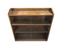 A set of Edwardian oak sliding glass door bookshelves,