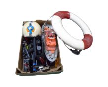 A box of Sky diving helmet, wooden life boat model, binoculars, camera tripod,