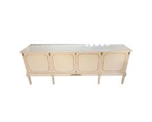 A continental white and gilt four door buffet sideboard on raised legs,