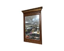 A decorative mahogany and gilt framed bevelled mirror
