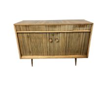 A mid century Everest teak two door three drawer sideboard on raised legs,