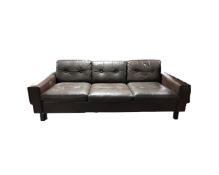 A 1970's Danish brown buttoned leather three piece lounge suite comprising of three seater,