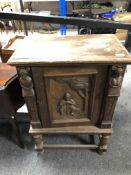 An early 20th century carved oak cabinet,