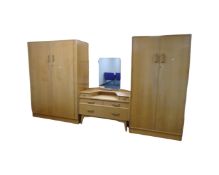 A four piece mid century G-Plan E Gomme light oak bedroom suite comprising of two double door