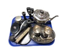A tray containing assorted plated wares, trophies, ebonised dressing table pieces.