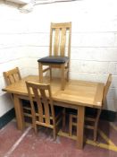 A contemporary oak extending dining table, length 153 cm,