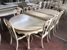 A continental white and gilt circular extending dining table with four leaves, total length 355 cm,